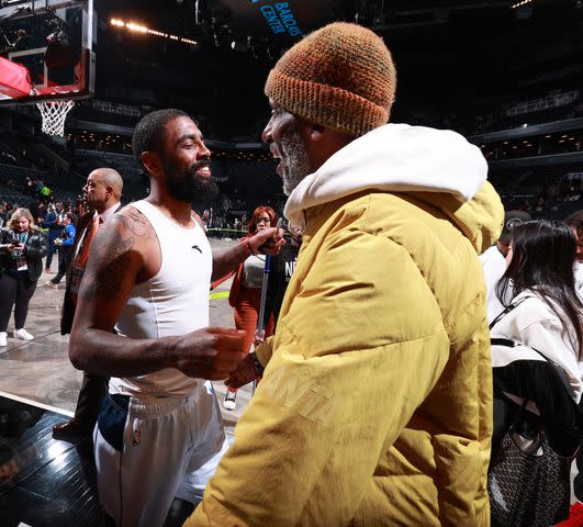 <p>Nathaniel S. Butler/NBAE via Getty</p> Kyrie Irving of the Dallas Mavericks and his dad, Drederick, after a game in February 2024.
