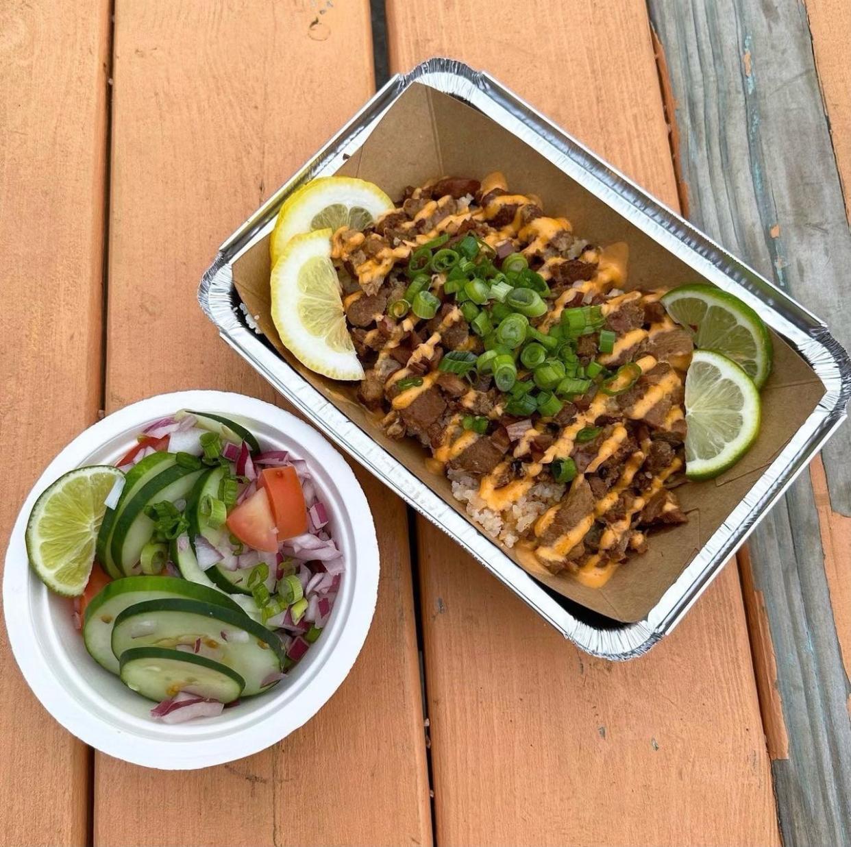 Cocina Filipina serves cucumber salad (left) and Cerdo Caliente, made with slow-cooked marinated pork, pickled red onions, house-made sriracha aioli, topped with green onions over rice.