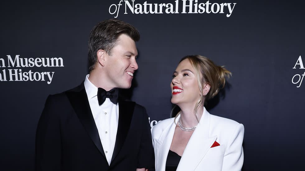 a man and woman standing on a red carpet