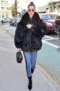 <p>Bella bundles up in a fur coat, light wash lace-up skinny jeans, velvet pointed-toe booties, a black handbag, red-tinted sunglasses, flashy silver rings and layered gold necklaces while out in NYC. </p>