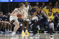 West Virginia guard Sean McNeil, left, is defended by Connecticut guard Jordan Hawkins (24) during the first half of an NCAA college basketball game in Morgantown, W.Va., Wednesday, Dec. 8, 2021. (AP Photo/Kathleen Batten)