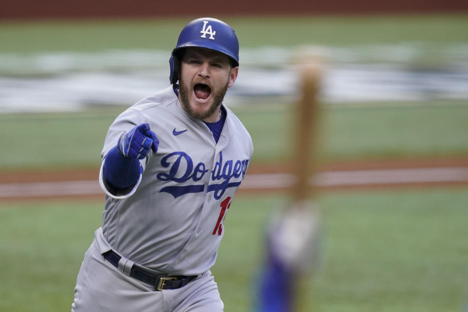 Los Angeles Dodgers' Max Muncy celebrates his grand slam home run during the first inning in Game 3 of a baseball National League Championship Series against the Atlanta Braves Wednesday, Oct. 14, 2020, in Arlington, Texas. (AP Photo/Eric Gay)