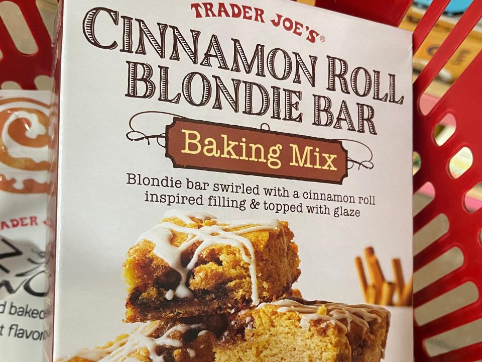 box of cinnamon roll blondie bar mix on a shopping basket at trader joes