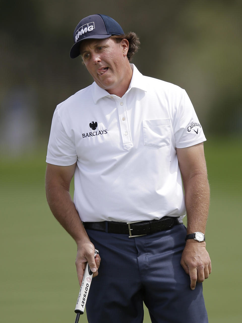 Phil Mickelson reacts as he misses an eagle putt on the 14th hole during the third round of the Texas Open golf tournament, Saturday, March 29, 2014, in San Antonio. Mickelson withdrew from the tournament with a pulled muscle. (AP Photo/Eric Gay)