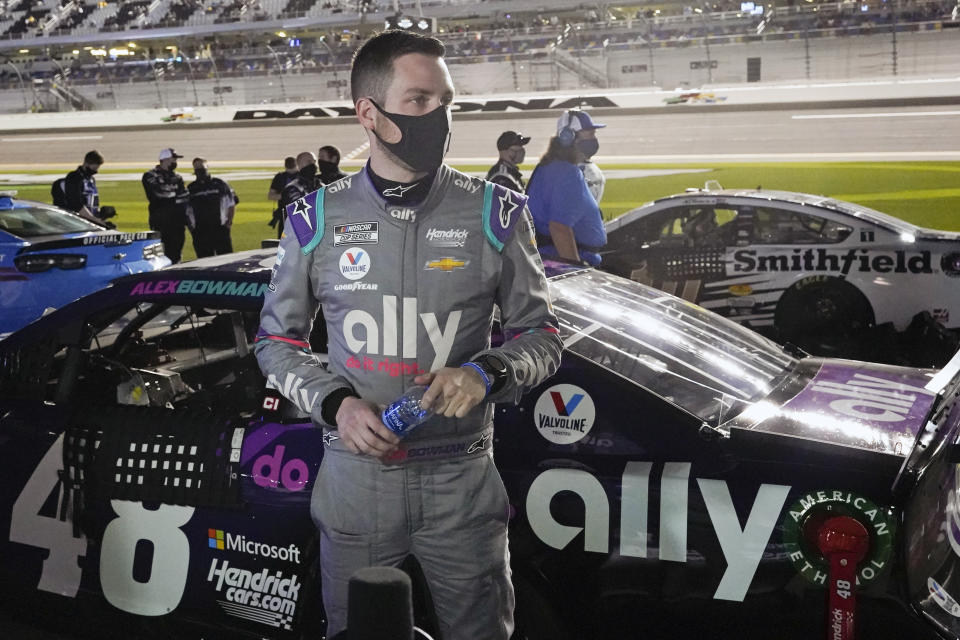 Alex Bowman stands by his car on pit road before the first of two qualifying NASCAR auto races for the Daytona 500 at Daytona International Speedway, Thursday, Feb. 11, 2021, in Daytona Beach, Fla. (AP Photo/John Raoux)