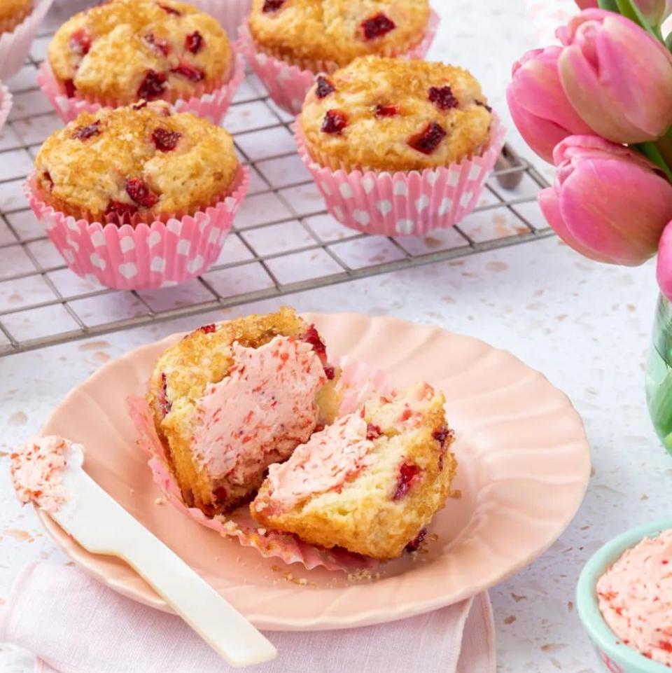 strawberry muffins cut open with strawberry butter and pink flowers