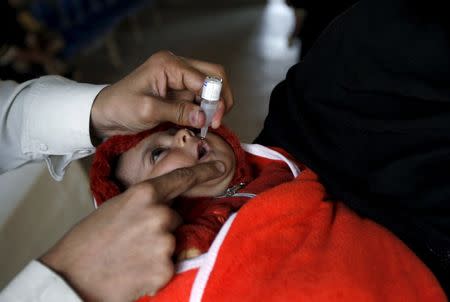 A baby girl receives polio vaccine drops at the vaccination center in Karachi, Pakistan, February 15, 2016. REUTERS/Akhtar Soomro