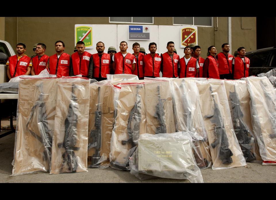 Fourteen alleged members of 'Los Zetas' drug cartel and seized weapons are presented to the press in Monterrey, Nuevo Leon state, Mexico on February 15, 2012. More than 40,000 people have been killed in rising drug-related violence in Mexico since December 2006, when President Felipe Calderon deployed soldiers and federal police to take on organized crime. (Julio Cesar Aguilar/AFP/Getty Images)