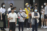 People wear face masks to help protect against the spread of the coronavirus in Taipei, Taiwan, Thursday, April 28, 2022. Taiwan, which had been living mostly free of COVID-19, is now facing its worst outbreak since the beginning of the pandemic with over 11,000 new cases reported Thursday. (AP Photo/Chiang Ying-ying)