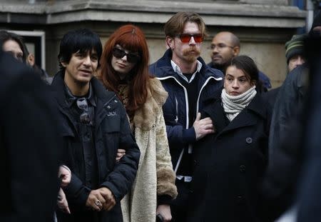 Eagles of Death Metal band and relatives including Jesse Hughes (C) stand in front of Paris 11th district town hall, France, November 13, 2016, during a ceremony held for the victims of last year's Paris attacks which targeted the Bataclan concert hall as well as a series of bars and killed 130 people. REUTERS/Gonzalo Fuentes