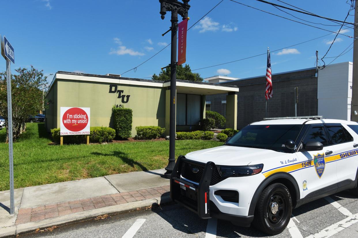 A JSO officer stands watch on the front of the building as FBI and IRS agents conduct a search of the Duval Teachers United building at 1601 Atlantic Blvd. near Landon Middle School in Jacksonville on Wednesday, September 6, 2023.