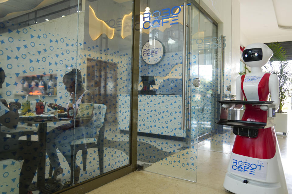 Robotic waiter serves customers at a Robot Cafe in Nairobi, Kenya Thursday, Aug. 29, 2024. The three robots, christened Claire, R24 and Nadia, are not programmed to have a full conversation with customers, but they can say "Your order is ready, Welcome" then people have to press an exit button after picking up their food from the tray. (AP Photo/Brian Inganga)