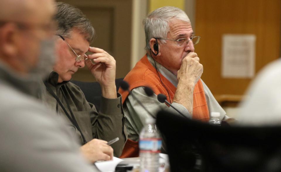 Danny Blanton listens as Peter Nilson speaks about facility assessment scoring in front of the Board of Education during a Public Hearing Tuesday evening, Jan. 25, 2022, at CCS Central Office on West Marion St. in Shelby.