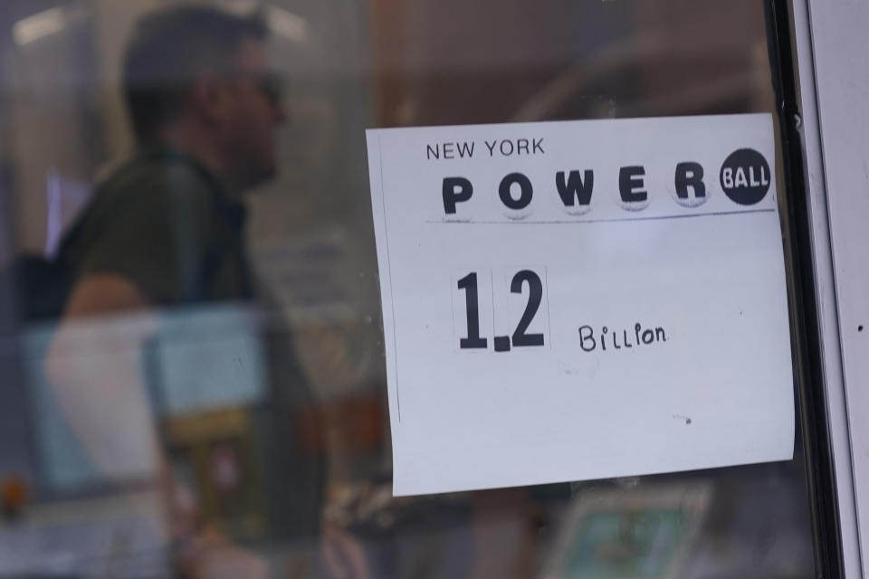 A sign on a convenience store advertises the Powerball lottery in New York, Tuesday, Nov. 1, 2022. The jackpot climbed to $1.2 billion after no one matched all six numbers to win the jackpot. (AP Photo/Seth Wenig)