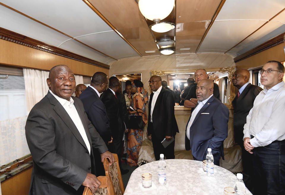 In this photo provided by the South African Government Communications and Information Services (GCIS) South African President Cyril Ramaphosa, left, and other delegates travel on a train towards Kyiv, from Warsaw, Poland, Thursday, June 15, 2023. Ramaphosa is taking part in the African Peace Mission aimed at a peaceful resolution of the conflict between Ukraine and Russia. (South African Government Communication and Information Services via AP)