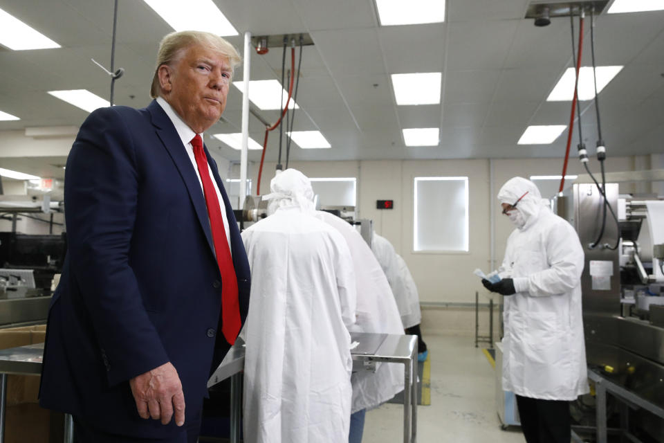 President Donald Trump roams the factory floor at Puritan Medical Products in Guilford, Maine, around suited-up employees working with sterile COVID-19 testing swabs. (Photo: ASSOCIATED PRESS)