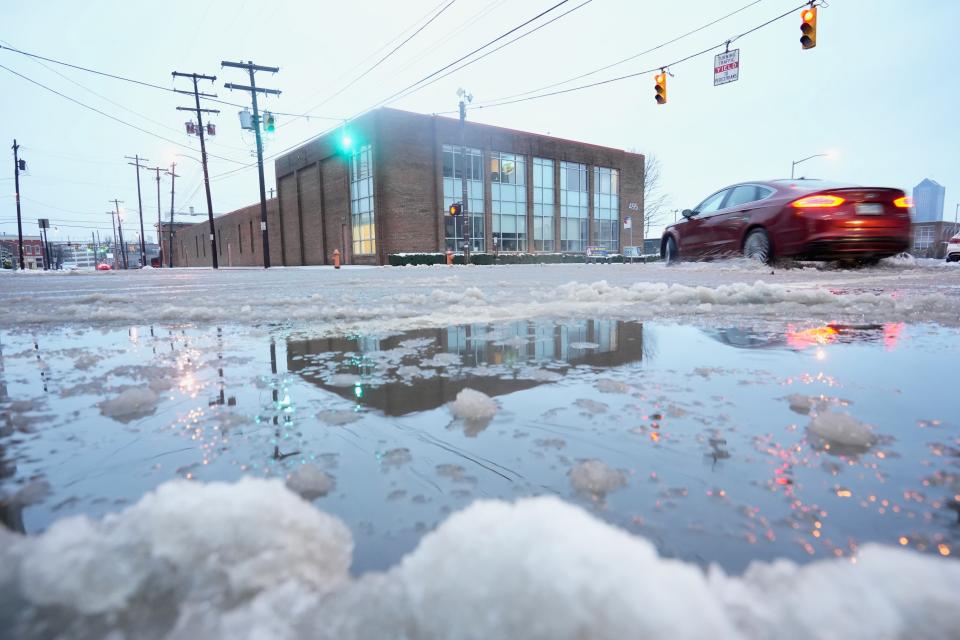 Rain mixed with snow made for slushy conditions at the intersection of East Main Street and South Washington Avenue in downtown Columbus on Wednesday morning.