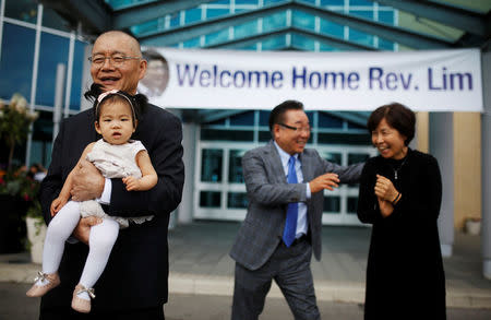 Pastor Hyeon Soo Lim, who returned to Canada from North Korea after the DPRK released Lim on August 9, after being held for 31 months, holds his granddaughter in front of his wife Geum Young Lim, as he leaves the Light Presbyterian Church in Mississauga, Ontario, Canada, August 13, 2017. REUTERS/Mark Blinch