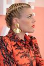 <p>French braid each side of a middle part into a low bun like actress Busy Phillips.</p>