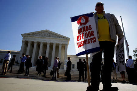 Demonstrators rally during oral arguments in Gill v. Whitford, a case about partisan gerrymandering in electoral districts, at the Supreme Court in Washington, U.S., October 3, 2017. REUTERS/Joshua Roberts