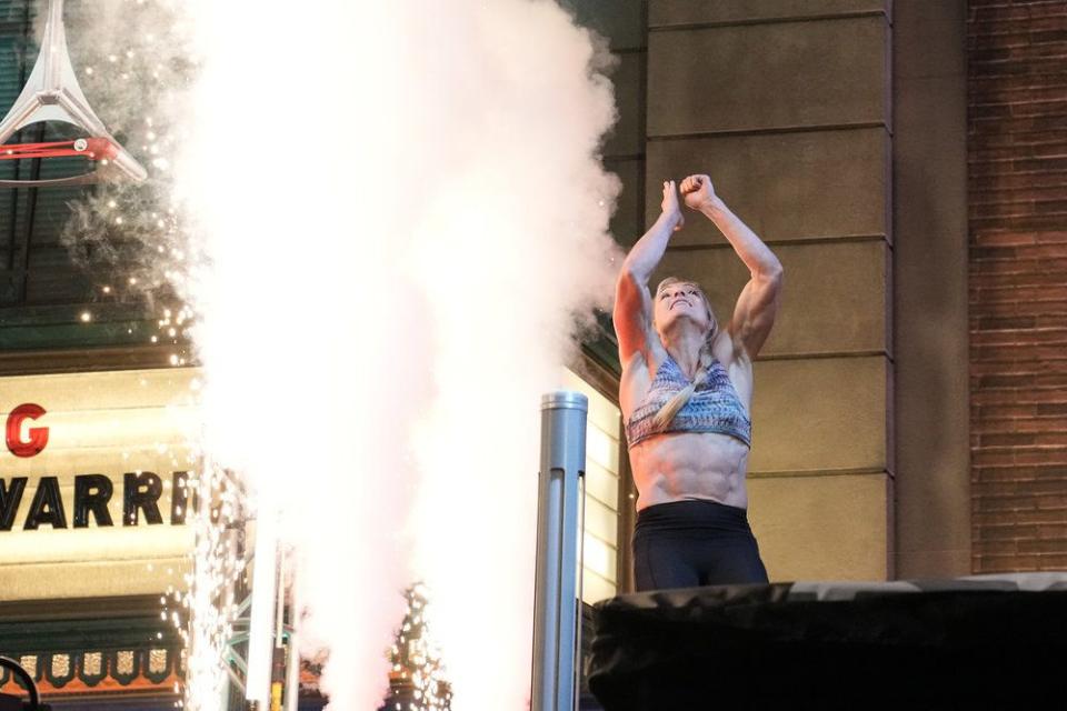 Ally Tippetts Wootton hits the buzzer after completing a course during the qualifying round of “American Ninja Warrior.” | Elizabeth Morris, NBC