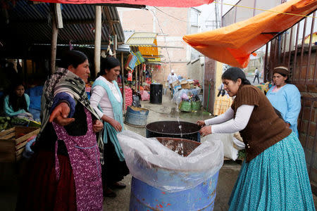 Women recover rain water during a water drought season in Chasquipampa, La Paz, Bolivia, November 28, 2016. REUTERS/David Mercado