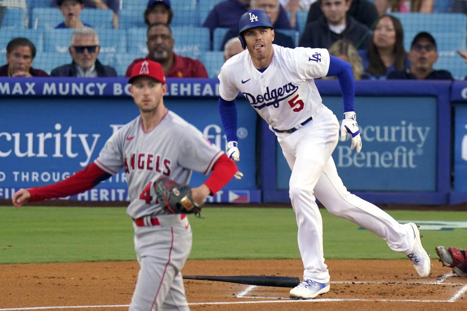 Los Angeles Dodgers' Freddie Freeman, right, heads to first after hitting a solo home run as Los Angeles Angels starting pitcher Griffin Canning watches during the first inning of a baseball game Friday, July 7, 2023, in Los Angeles. (AP Photo/Mark J. Terrill)