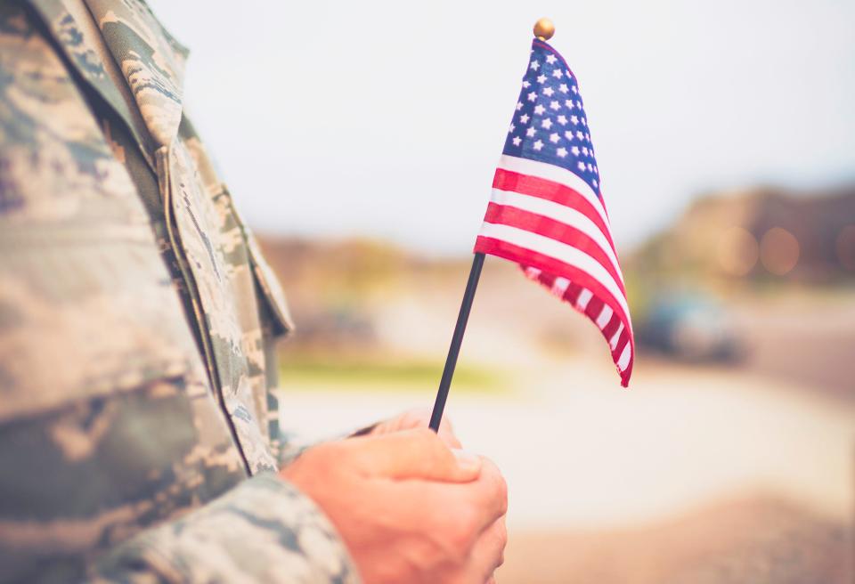 American military soldier with flag. Patriotic theme