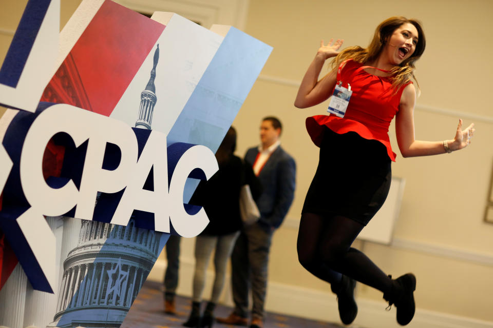<p>Elizabeth Mills jumps in front of the Conservative Political Action Conference (CPAC) sign at National Harbor, Md., Feb. 23, 2018. (Photo: Joshua Roberts/Reuters) </p>