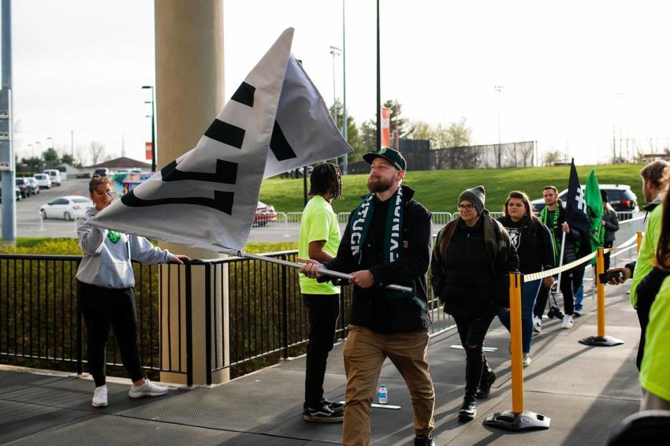 Lexington Sporting Club fans make their way into the stadium before the club’s first home match against Forward Madison FC at Toyota Stadium in Georgetown on Saturday. The team’s supporters group, The Railbirds, has a special section to sit and stand in at Toyota Stadium.