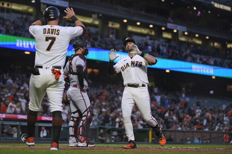 San Francisco Giants' Evan Longoria (10) celebrates with J.D. Davis (7) after hitting a two-run home run against the Arizona Diamondbacks during the fourth inning of a baseball game in San Francisco, Monday, Aug. 15, 2022. (AP Photo/Godofredo A. Vásquez)