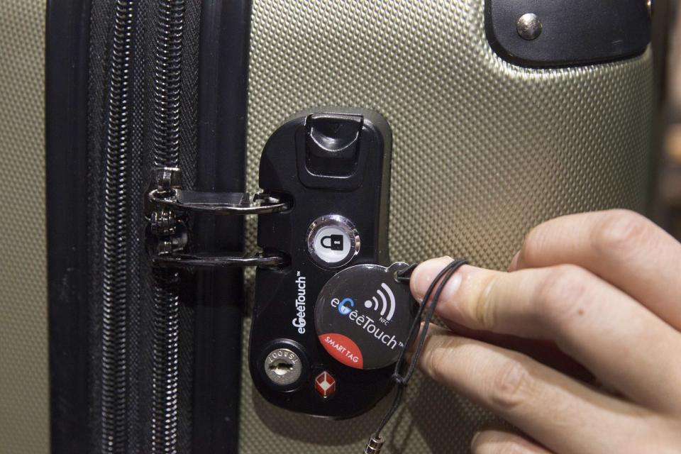 An eGeeTouch smart luggage lock is displayed during the 2015 International Consumer Electronics Show (CES) in Las Vegas, Nevada January 4, 2015. The TSA-approved locks can be unlocked with pre-paired NFC tag (shown) or by using an App on an Android smart phone. REUTERS/Steve Marcus