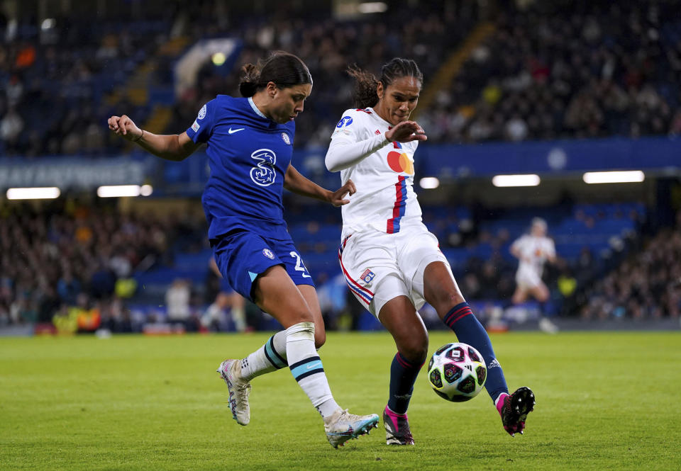 FILE - Chelsea's Sam Kerr, left, and Lyon's Wendie Renard battle for the ball during the Women's Champions League quarterfinal second leg match at Stamford Bridge, London, Thursday March 30, 2023. By the end of the Women's World Cup, the France captain hopes she'll be raising aloft the major international trophy that has eluded the women's national team. Renard hopes a strong World Cup performance will boost the women's league back home. Interest waned after France hosted the 2019 edition. (Adam Davy/PA via AP, File)