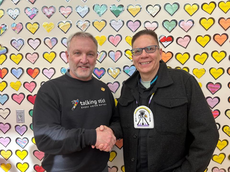 Robert Head, right, chief of Peter Chapman, one of the bands that make up James Smith Cree Nation, shakes hands with TryCycle Data Systems CEO John MacBeth at the unveiling of the new FirstAlerts emergency alert system Wednesday.