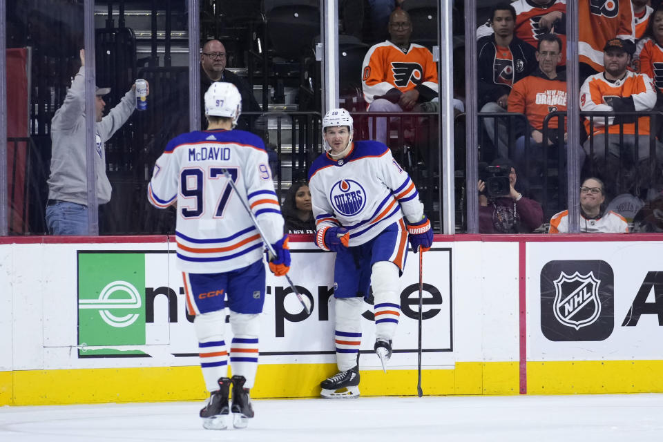 Edmonton Oilers' Zach Hyman (18) and Connor McDavid (97) celebrate after a goal by Hyman during the second period of an NHL hockey game against the Philadelphia Flyers, Thursday, Oct. 19, 2023, in Philadelphia. (AP Photo/Matt Slocum)