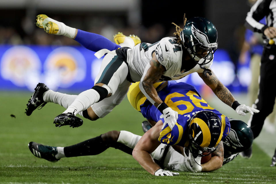 Los Angeles Rams tight end Tyler Higbee is tackled by Philadelphia Eagles cornerback Cre'von LeBlanc, top, and cornerback Rasul Douglas during the first half in an NFL football game Sunday, Dec. 16, 2018, in Los Angeles. (AP Photo/Marcio Jose Sanchez)