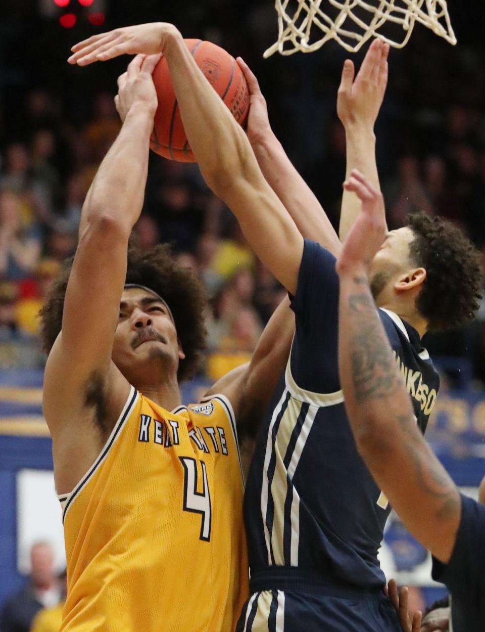 Kent State's Chris Payton goes to the hoop as Akron's Trendon Hankerson defends during Friday night at the M.A.C. Center in Kent.