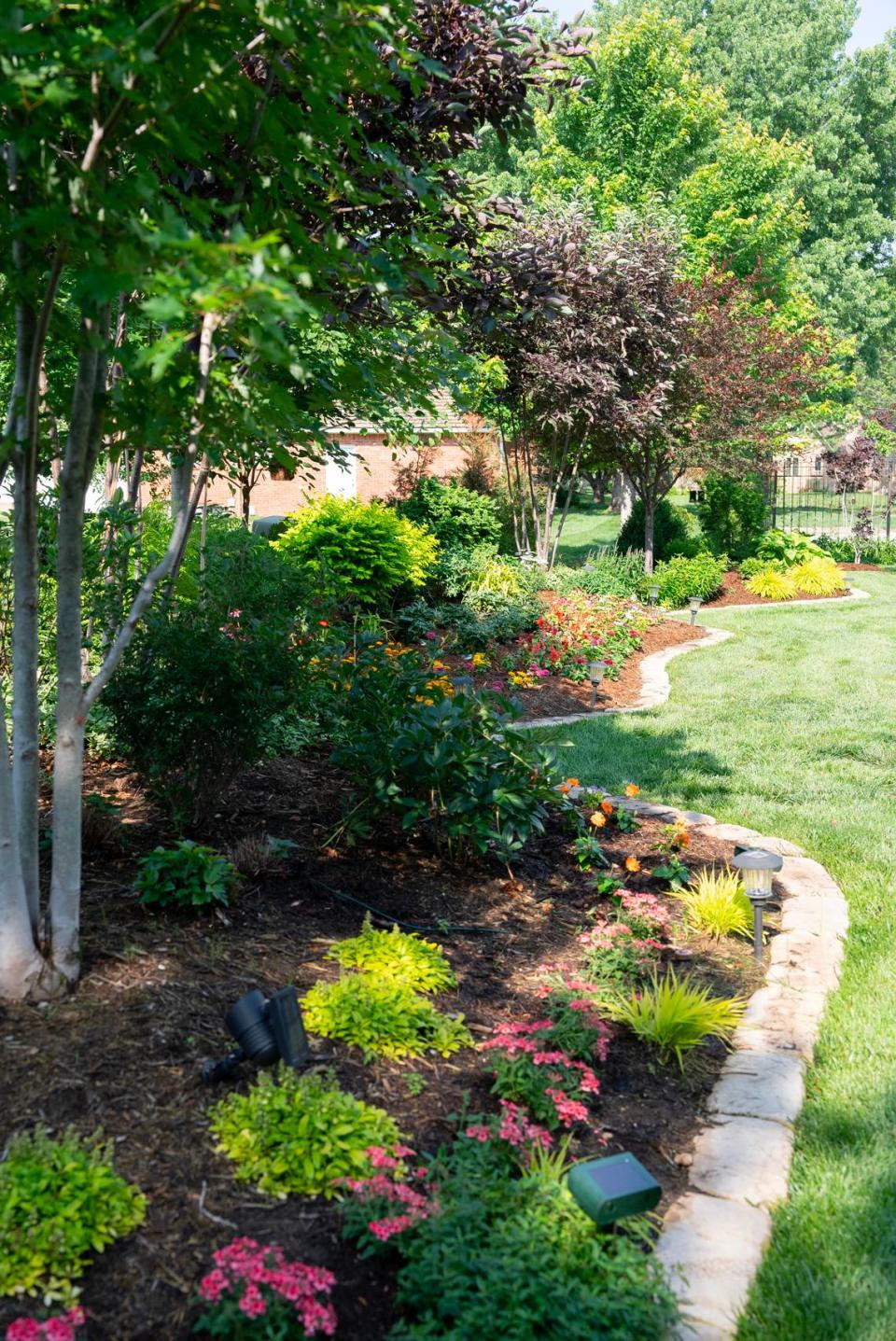 Stacy Trollinger’s backyard at 2510 N. Greenleaf Ct. is filled with more than 25 trees and a colorful variety of shrubs, plants, and flowers. Her backyard and her neighbor’s yard will be on the Sedgwick County Extension’s annual garden tour.