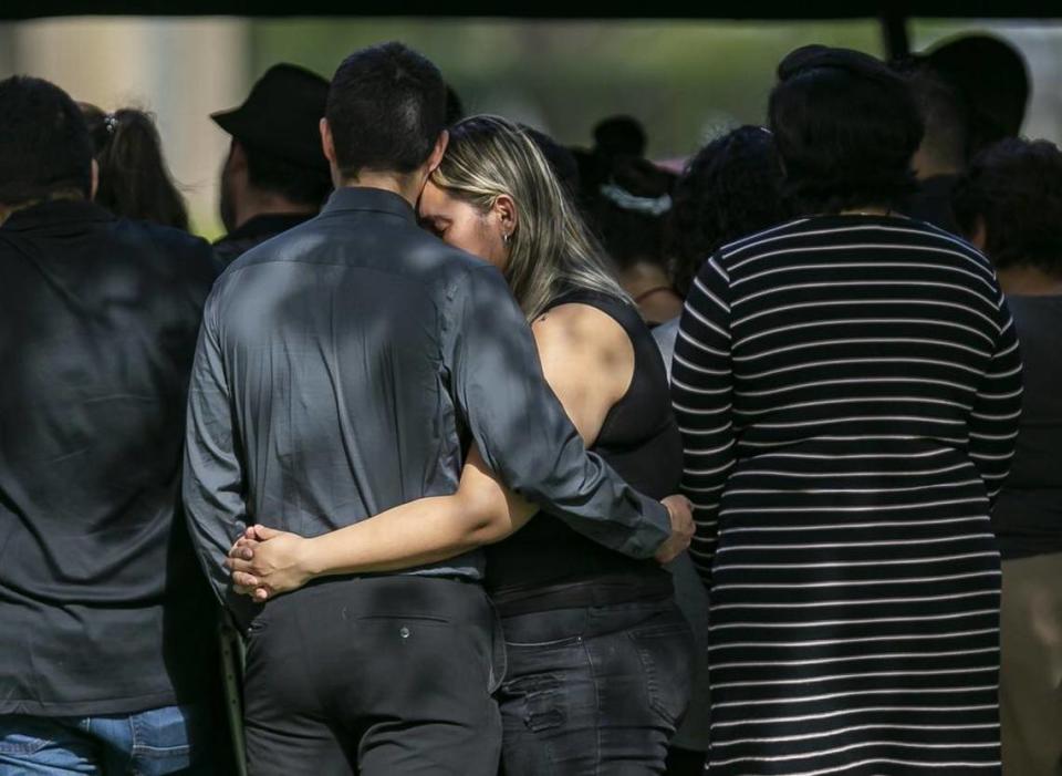 Family and friends gather at the Vista Memorial Gardens cemetery in Miami Lakes on Tuesday for the burial service of Frank Ordonez, the UPS driver who was taken hostage by armed robbers and killed during a shootout with police last Thursday.