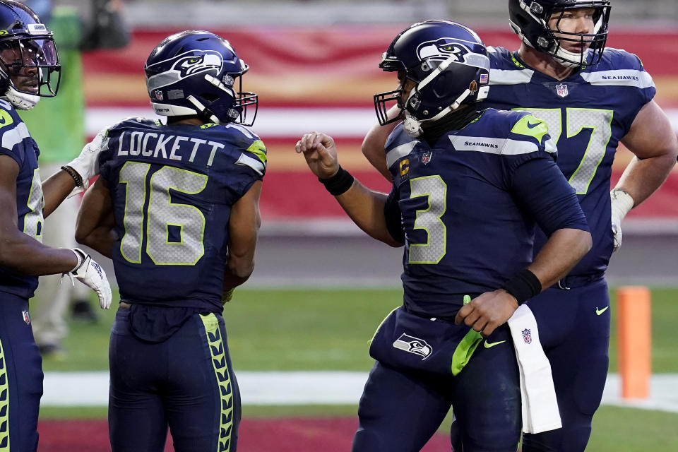 Seattle Seahawks wide receiver Tyler Lockett (16) celebrates his touchdown with quarterback Russell Wilson (3) during the second half of an NFL football game against the San Francisco 49ers, Sunday, Jan. 3, 2021, in Glendale, Ariz. (AP Photo/Ross D. Franklin)