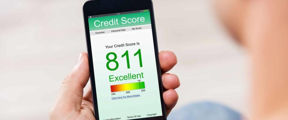 Man Holding Smart Phone Showing Credit Score Application On A Screen