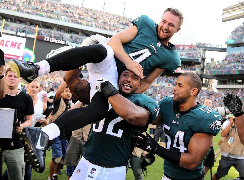 <p>Jake Elliott #4 of the Philadelphia Eagles is picked up by teammates Najee Goode #52 and Kamu Grugier-Hill #54 after Elliott kicked the game winning field goal with 1 second left in the game against the New York Giants on September 24, 2017 at Lincoln Financial Field in Philadelphia, Pennsylvania.Elliott kicked the 61 yard field goal to defeat the New York Giants 27-24. (Photo by Elsa/Getty Images) </p>