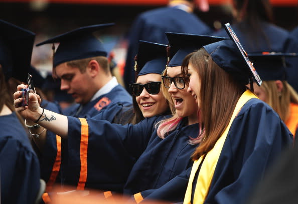 Syracuse University graduates take a picture together during the 2012 Syracuse University Commencement at Syracuse University on May 13, 2012 at the Carrier Dome in Syracuse, New York. (Photo by Nate Shron/Getty Images)