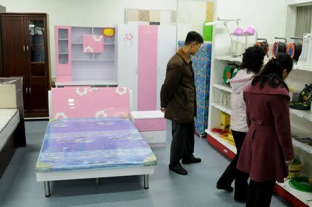 North Korean people shop at Kwangbok department store in central Pyongyang, North Korea, in this March 16, 2014 handout photo. REUTERS/Handout via Reuters