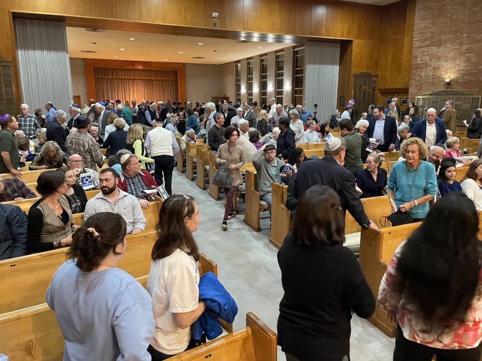 A gathering of people rise to leave Adas Yeshurun synagogue Thursday evening in Augusta after a meeting that urged solidarity with Israel after recent attacks on the Jewish nation from Palestinian militants on the Gaza Strip.