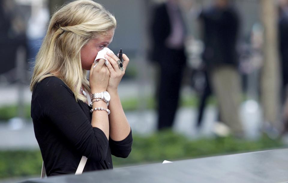 Kayla Fallon, daughter of William Fallon who perished in Tower One when she was 8 years, old reacts when she visits the 9/11 Memorial during ceremonies marking the 12th anniversary of the 9/11 attacks on the World Trade Center in New York September 11, 2013. (REUTERS/John Angelillo)