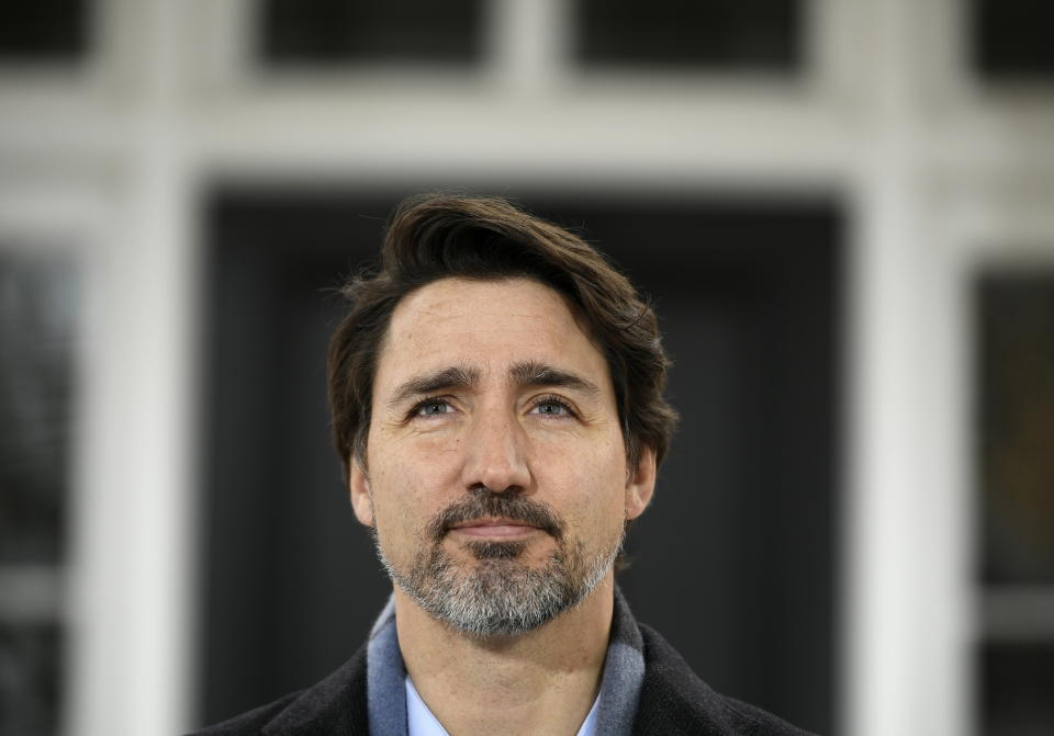 Prime Minister Justin Trudeau listens to questions during his daily press conference on COVID-19, in front of his residence at Rideau Cottage, on the grounds of Rideau Hall in Ottawa, on Saturday, March 28, 2020. (Justin Tang/The Canadian Press via AP)