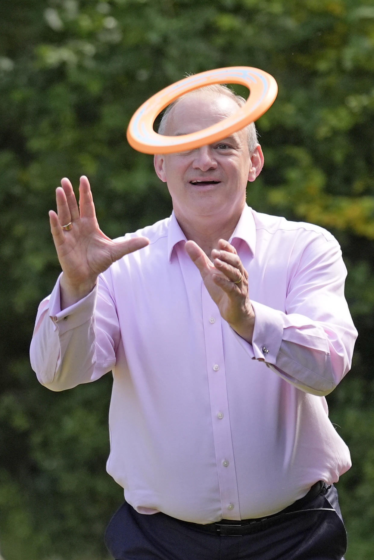 Lib Dem leader Sir Ed Davey upgrades his knighthood to a sainthood as he plays with a frisbee during a visit to Crowd Hill Farm, Hampshire (Andrew Matthews/PA)