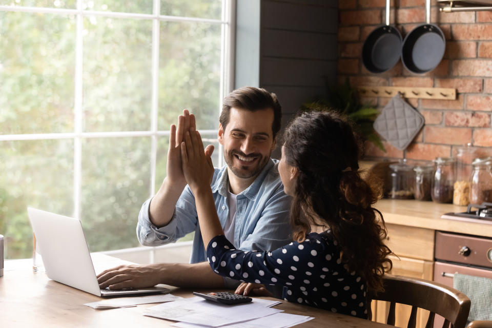 couple high fiving after making their budget