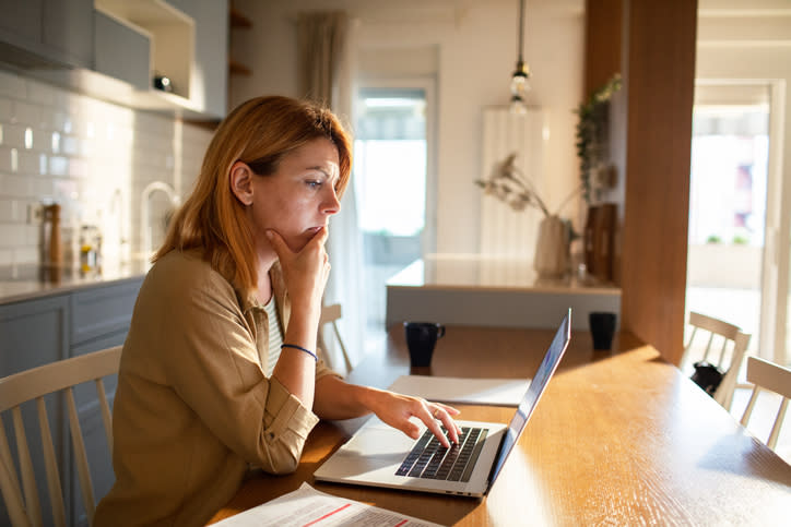 A woman researching how debt is divided during a divorce.